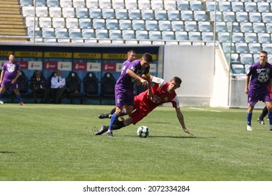 ODESSA, UKRAINE - Aug 24, 2021: Football. Traditional Cup Of Ukraine Among ATO Veterans. Veterans Play Football On Green Lawn Of  Stadium. Game Moment Of Football Fight For Cup. Vivid Emotions Of Game