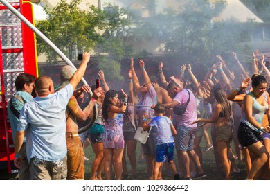 ODESSA, UKRAINE - August 5, 2017: Young people, boys and girls are having fun during the Holi holiday, throwing colorful powder at each other. Boys and girls in wet clothes have fun. Wet party - Shutterstock ID 1029366442