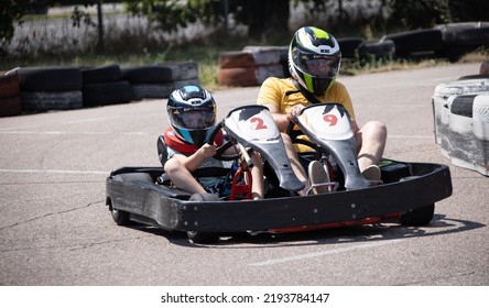 ODESSA, UKRAINE - August 7, 2022: Healthy Lifestyle. Sport Family. Family Vacation At Karting Track. Children With Parents Go In For Motorsports. Karting. Hobbies, Sports Education, Leisure And Lifestyle