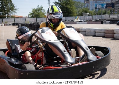 ODESSA, UKRAINE - August 7, 2022: Healthy Lifestyle. Sport Family. Family Vacation At Karting Track. Children With Parents Go In For Motorsports. Karting. Hobbies, Sports Education, Leisure And Lifestyle