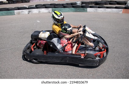 ODESSA, UKRAINE - August 7, 2022: Healthy Lifestyle. Sport Family. Family Vacation At Karting Track. Children With Parents Go In For Motorsports. Karting. Hobbies, Sports Education, Leisure, Lifestyle