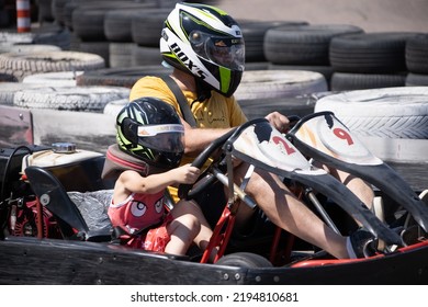 ODESSA, UKRAINE - August 7, 2022: Healthy Lifestyle. Sport Family. Family Vacation At Karting Track. Children With Parents Go In For Motorsports. Karting. Hobbies, Sports Education, Leisure, Lifestyle