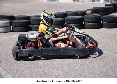 ODESSA, UKRAINE - August 7, 2022: Healthy Lifestyle. Sport Family. Family Vacation At Karting Track. Children With Parents Go In For Motorsports. Karting. Hobbies, Sports Education, Leisure, Lifestyle