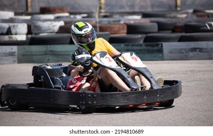 ODESSA, UKRAINE - August 7, 2022: Healthy Lifestyle. Sport Family. Family Vacation At Karting Track. Children With Parents Go In For Motorsports. Karting. Hobbies, Sports Education, Leisure, Lifestyle