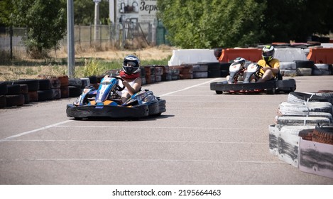 ODESSA, UKRAINE - August 7, 2022: Healthy Lifestyle. Sport Family. Family Vacation At Karting Track. Children With Parents Go In For Motorsports. Karting. Hobbies, Sports Education, Leisure, Lifestyle