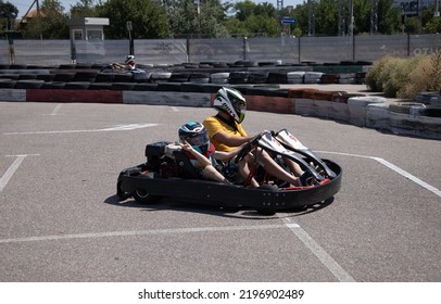 ODESSA, UKRAINE - August 7, 2022: Healthy Lifestyle. Sport Family. Family Vacation At Karting Track. Children With Parents Go In For Motorsports. Karting. Hobbies, Sports Education, Leisure, Lifestyle