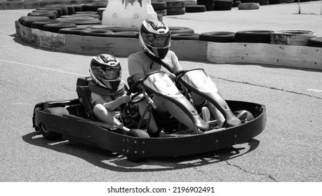 ODESSA, UKRAINE - August 7, 2022: Healthy Lifestyle. Sport Family. Family Vacation At Karting Track. Children With Parents Go In For Motorsports. Karting. Hobbies, Sports Education, Leisure, Lifestyle