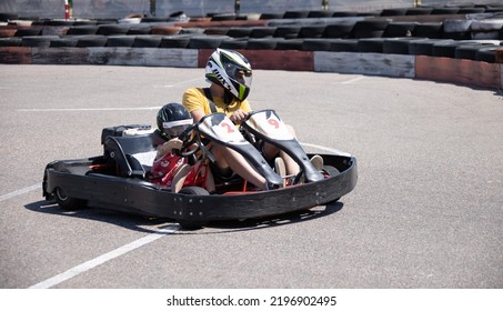 ODESSA, UKRAINE - August 7, 2022: Healthy Lifestyle. Sport Family. Family Vacation At Karting Track. Children With Parents Go In For Motorsports. Karting. Hobbies, Sports Education, Leisure, Lifestyle