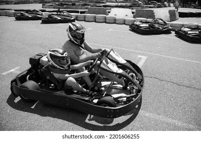 ODESSA, UKRAINE - August 7, 2022: Healthy Lifestyle. Sport Family. Family Vacation At Karting Track. Children With Parents Go In For Motorsports. Karting. Hobbies, Sports Education, Leisure, Lifestyle