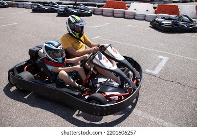 ODESSA, UKRAINE - August 7, 2022: Healthy Lifestyle. Sport Family. Family Vacation At Karting Track. Children With Parents Go In For Motorsports. Karting. Hobbies, Sports Education, Leisure, Lifestyle