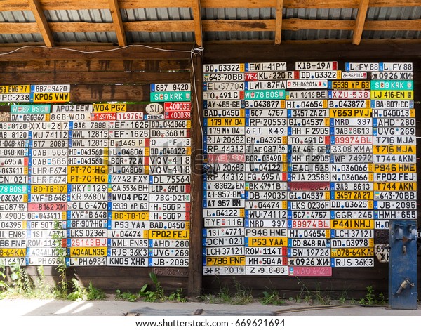 Odessa, Ukraine - circa 2017: License numbers\
auto from all over world on display. Discontinued license plate of\
cars from Europe car on wall. Background of vintage antique car\
license plates Europe.