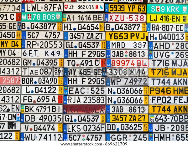 Odessa, Ukraine - circa 2017: License numbers\
auto from all over world on display. Discontinued license plate of\
cars from Europe car on wall. Background of vintage antique car\
license plates Europe.