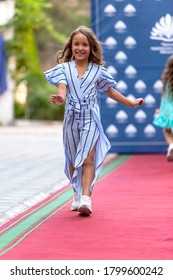 Odessa, Ukraine - CIRCA 2020: Children's Fashion Show. Presentation of young models in fashionable clothes on the red carpet defile. Models walk the runway at the presentation of the collection