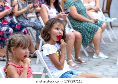 Odessa, Ukraine - CIRCA 2020: Selective Focus. Spectators-children In Summer Theater During Popular Children's Play. Children's Delight Of Audience. Concert Audience. Children's Spectators In Theater