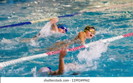 ODESSA, UKRAINE - CIRKA 2016: Children, athletes, swimmers swim along tracks in sports pool for swimming. Sports swimming in pool. Summer Olympic sport, healthy lifestyle, children's sport