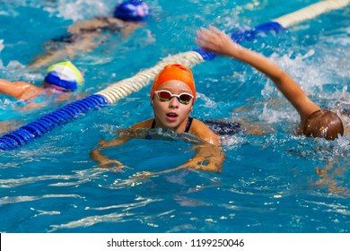 ODESSA, UKRAINE - CIRKA 2016: Children, athletes, swimmers swim along tracks in sports pool for swimming. Sports swimming in pool. Summer Olympic sport, healthy lifestyle, children's sport