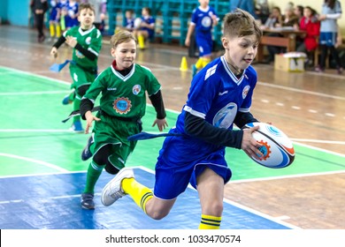 ODESSA, UKRAINE- Febr 24,2018: Young children play rugby during derby games of city school in closed hall. Children's sports. Children play in rugby 5. Fight for victory of children. Healthy lifestyle