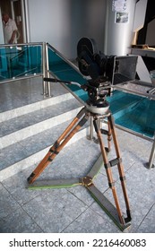 ODESSA, UKRAINE - JUL 16, 2014: 35mm Movie Camera, With Magazine, Lens And Matbox, On Fluid Head And Wooden Tripod With Spreaders, In Interior Lobby Of Odesa Film Studio.