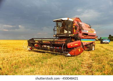 ODESSA, UKRAINE - July 11, 2016: The beginning of the harvest of ripe wheat. Modern harvester removes the ripe corn in field. Seasonal agricultural work, use of heavy specialized machinery on the farm - Shutterstock ID 450048421