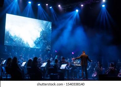 ODESSA, UKRAINE - July 16, 2019: Concert Of The Andrei Cherny Symphony Orchestra On The Theatrical Stage Of The Odessa Opera House. Musicians Of The Symphony Orchestra Perform OSCAR Cinematic Hits