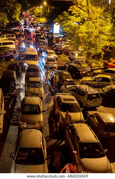 ODESSA, UKRAINE - July 28, 2017: Night\
traffic jam on city road. Resort area of night clubs and\
restaurants. Cars created traffic jam in city center.\
