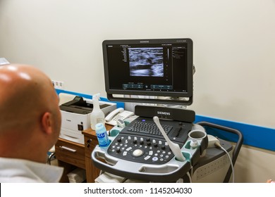 ODESSA, UKRAINE - July 29, 2018: Woman undergoes medical examination of veins on ultrasound sensor in modern technology clinic. Condition of veins and examination of doppler on monitor - Shutterstock ID 1145204030
