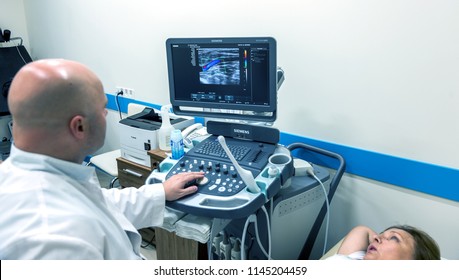 ODESSA, UKRAINE - July 29, 2018: Woman undergoes medical examination of veins on ultrasound sensor in modern technology clinic. Condition of veins and examination of doppler on monitor - Shutterstock ID 1145204459