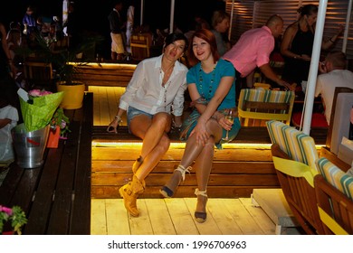 Odessa, Ukraine July 7, 2013: Ibiza Night Club. Women Smiling And Posing On Cam During Concert In Night Club Party. Girl Have Fun At Club. Girl At Night Club Party. Girl Smoke Hookan And Drink Alcohol