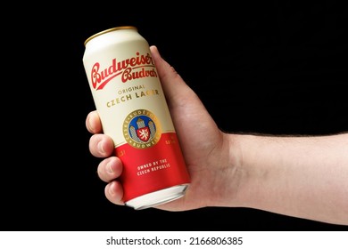 Odessa, Ukraine - June 03, 2022: A Man Offers A Can Of Beer Budweiser, Hand Holding A Can Of Beer Close-up, Black Background.