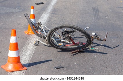 ODESSA, UKRAINE - June 13, 2019: Fatal accident car with a bicycle on a high-speed highway. Ricked bike after colliding with a car. Road accident on a city road