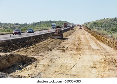 ODESSA, UKRAINE - June 18, 2017: Workers And Technicians Repair Road And Build New Lane Along Odessa-Kiev Highway. Repair And Construction Of Highways. Detour. Road Closed. Motorway