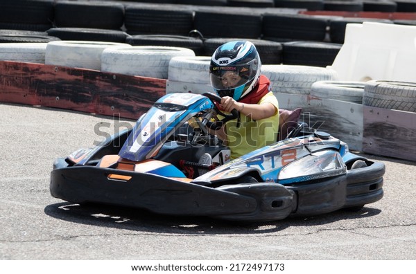 ODESSA,
UKRAINE - June 18, 2022: Karting. Go Kart on track. Young positive
girl racer in a helmet driving kart during car race on an auto
track outdoors. Extreme auto sport in sports
club
