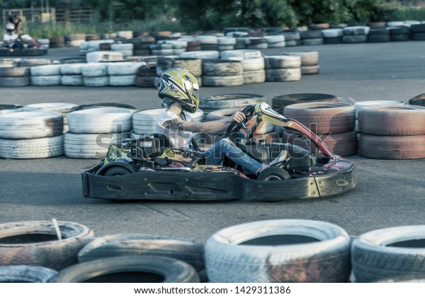 ODESSA, UKRAINE -\
June 19, 2019: karting. Racers on races on special safe high-speed\
tracks limited by car tires. Attraction High-speed ride in carts.\
Sport karting\
entertainment
