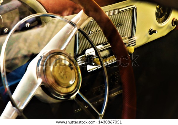 Odessa, Ukraine.\
June 2019. Detailed view of a Gaz Volga car, soviet car\
manufacturer. Closeup of steering wheel with dashboard, car radio\
and various buttons. Selected\
focus.