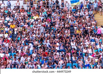 Odessa, Ukraine - June 25, 2016: crowd of spectators at concert during  creative light and music show. Crowds and queues of people on face-control, spectators in stands and field. People relaxing fun