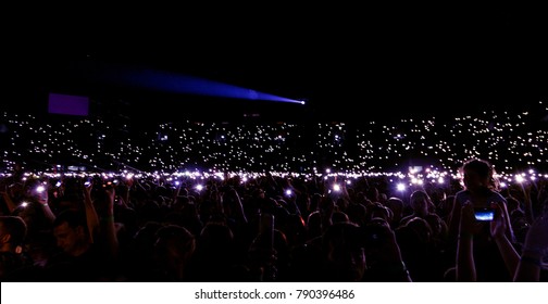 Odessa, Ukraine - June 25, 2016: Large Crowd Of Spectators Having Fun At Stadium, At Concert Of Ukrainian Group Ocean Elzy During Creative Light And Music Show. Cheerful Bright Show In Party Club