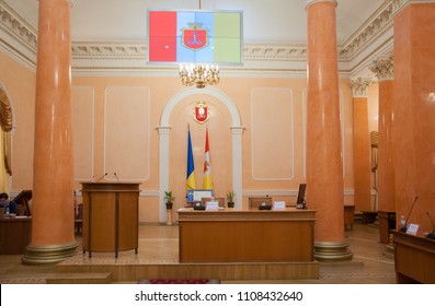 Odessa / Ukraine - June 6 2018
Working Place Of Odessa City Mayor Gennadiy Trukhanov In The Sessional Hall. Desk With Flags Of Odessa And Ukraine Behind And Columns. City Hall Interior