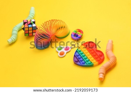 Odessa, Ukraine - june 7, 2022: Different antistress sensory toys on yellow background