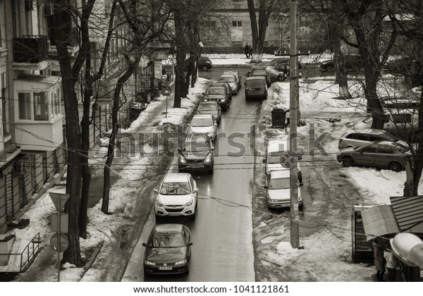 ODESSA, UKRAINE - March 7, 2018: Traffic jam in an\
hour-peak on small square as result of improper car parking. Police\
evacuate car violator parking rules. Top view from a bird\'s flight.\
Car jam