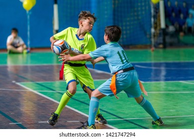 ODESSA, UKRAINE - MAY 18, 2019: Young children play rugby during final games of championship in hall. Children's sport. Children play rugby 5. Fight for victory of children in rugby