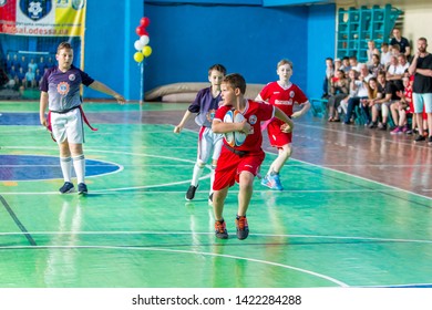 ODESSA, UKRAINE - MAY 18, 2019: Young children play rugby during final games of championship in hall. Children's sport. Children play rugby 5. Fight for victory of children in rugby