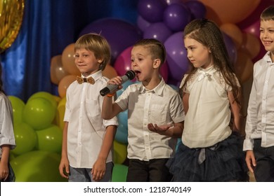Odessa, Ukraine - May 31,2018: Children's musical group sing and dance on stage during graduation concert of elementary school. Children play. Emotional children's show on stage. Children's creativity