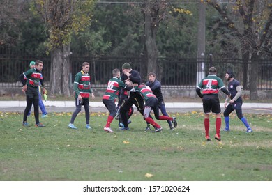 Odessa, Ukraine November 24, 2019: local Rugby clubs engaged in fierce fight on green unequipped field in Rugby Derby tournament. Contact fierce clash in Rugby athletes on statement of stadium. Battle