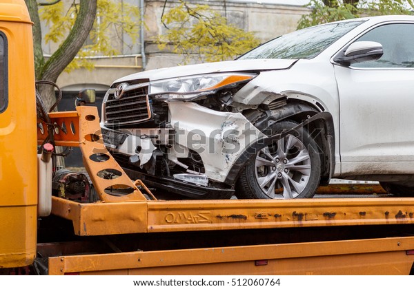 ODESSA, UKRAINE - November 8,2016: Broken car
after an accident is transported from accident to tow truck. Damage
after head-on collision jeep loaded on Tow truck for transportation
to repair shop STO