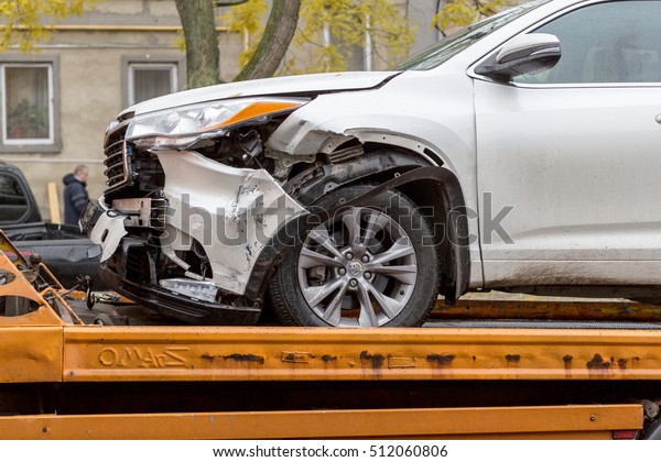 ODESSA, UKRAINE - November 8,2016: Broken car
after an accident is transported from accident to tow truck. Damage
after head-on collision jeep loaded on Tow truck for transportation
to repair shop STO