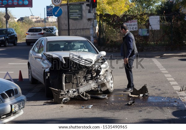 ODESSA, UKRAINE - October 16, 2019: Car accident,
head-on collision. A tow truck loads a wrecked car after an
accident. Traffic police officer during an investigation in a
traffic accident zone