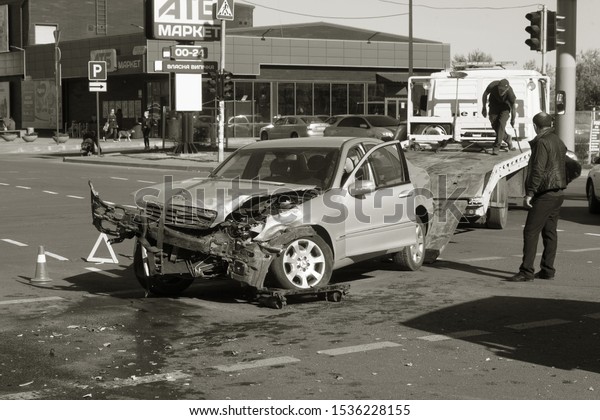 ODESSA, UKRAINE - October 16, 2019: Car accident,
head-on collision. A tow truck loads a wrecked car after an
accident. Traffic police officer during an investigation in a
traffic accident zone