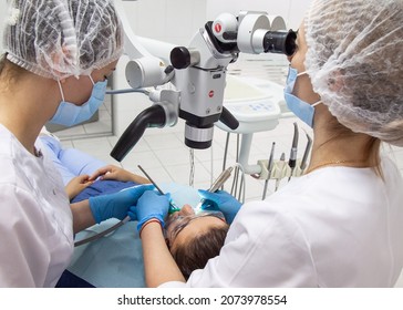 Odessa,Europe, Ukraine May, 20, 2020. Dental Treatment Under The Microscope, Women Dentist Treats Teeth Using A Microscope Dental Clinic 