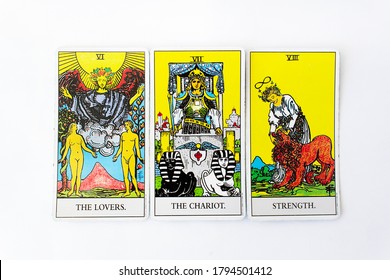 Odessa/Ukraine-July 29,2020: Number six seven  and eight major arcana the Lovers Chariot and Strength cards of Rider Waite esoteric deck on white background