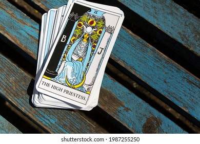 Odessa,Ukraine-May 14,2021: high priestess arcana tarot card of Rider Waite cards deck on blue wooden background 